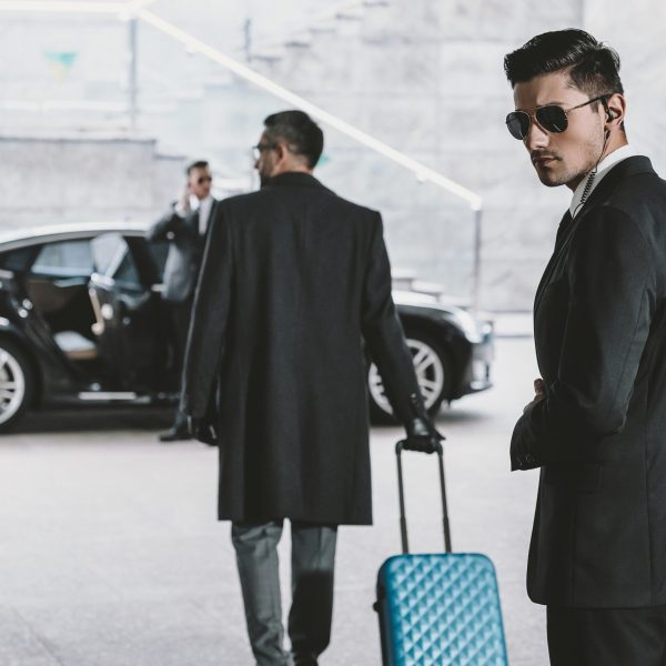 Businessman,Going,With,Blue,Wheeled,Bag,To,Car