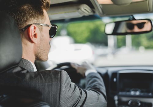 handsome-man-wearing-sunglasses-looking-rearview-mirror-car (1)